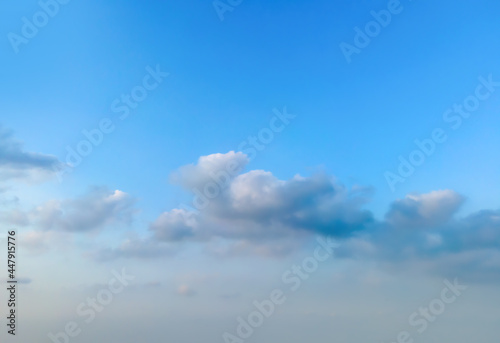 Looking up at the blue sky and white clouds background