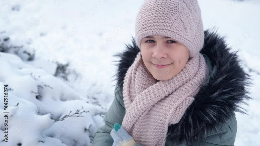 Teen by the snowy tree. A pretty teen look at camera and possing against snowy ground. Teen by the snowy tree. A pretty teen look at camera and possing against snowy ground.