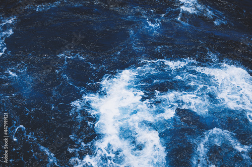 Dark blue texture of the sea with waves
