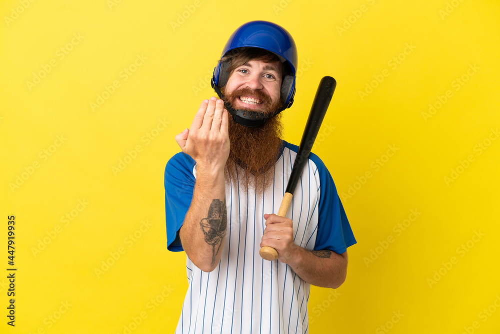 Redhead baseball player man with helmet and bat isolated on yellow background inviting to come with hand. Happy that you came Redhead baseball player man with helmet and bat isolated on yellow background inviting to come with hand. Happy that you came