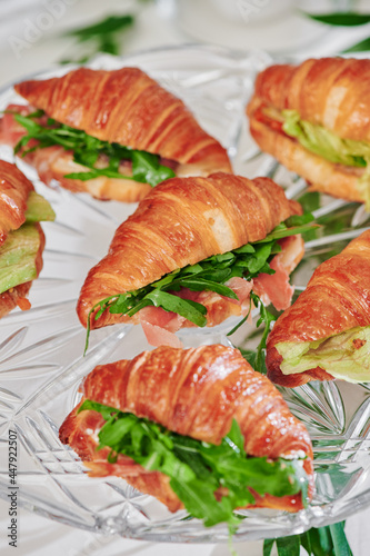 Mini croissants with filling on the festive table. Buffet, catering. High quality photo
