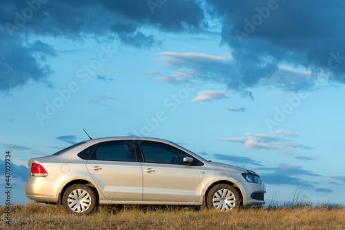 The car on the background of a beautiful sky, side view. Outdoor stop for camping. © imartsenyuk