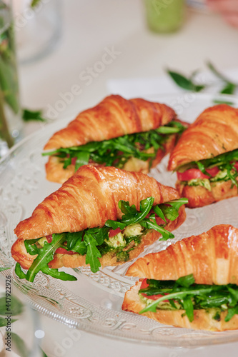 Mini croissants with filling on the festive table. Buffet, catering. High quality photo