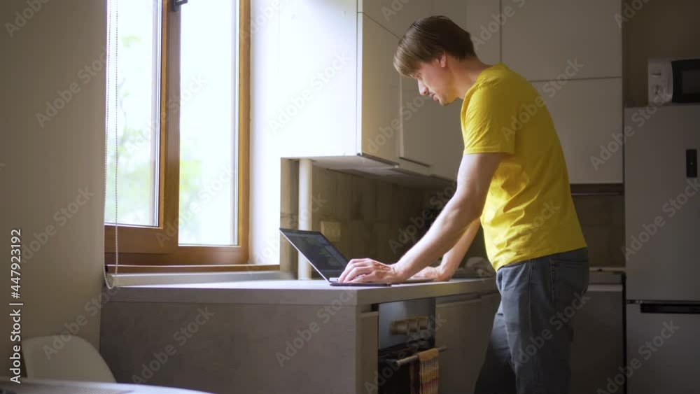 A man uses a laptop for distant work on a project. Work from home concept. A man uses a laptop for distant work on a project. Work from home concept.