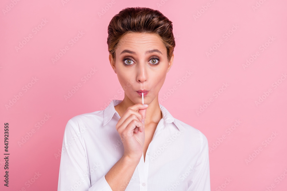 Photo of young happy amazed shocked woman eat candy sweet wear white shirt isolated on pink color background Photo of young happy amazed shocked woman eat candy sweet wear white shirt isolated on pink color background
