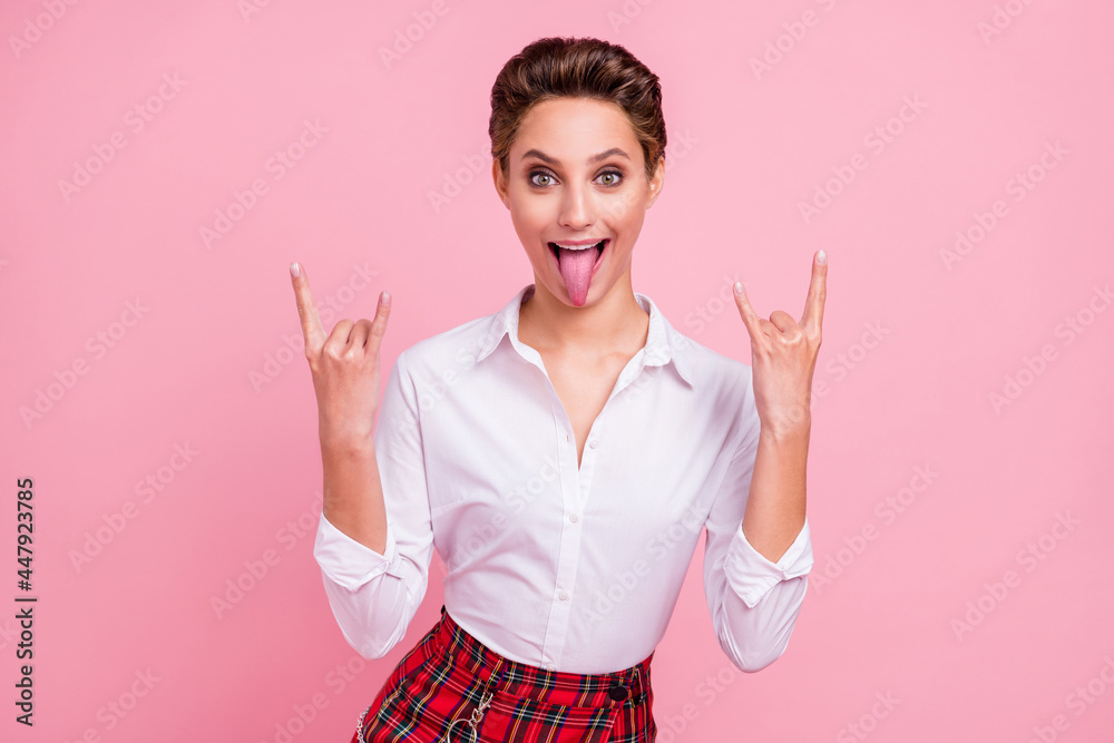 Photo of crazy happy positive woman make fingers horned signs good mood rock isolated on pink color background Photo of crazy happy positive woman make fingers horned signs good mood rock isolated on pink color background