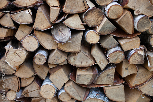 Firewood birch background. Pile of dry chopped wooden logs. Firewood storage.
