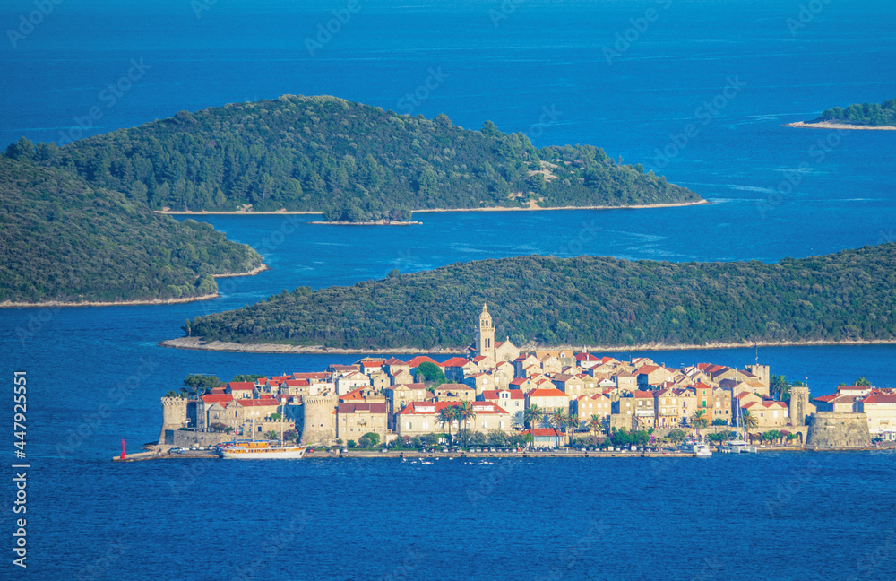 AERIAL: Tranquil old town of Korcula is surrounded by the tranquil Adriatic sea.