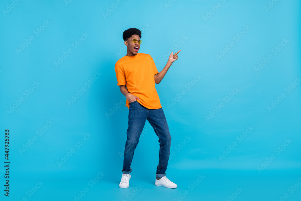 Full length body size view of attractive funky guy demonstrating copy space idea plan isolated over bright blue color background Full length body size view of attractive funky guy demonstrating copy space idea plan isolated over bright blue color background