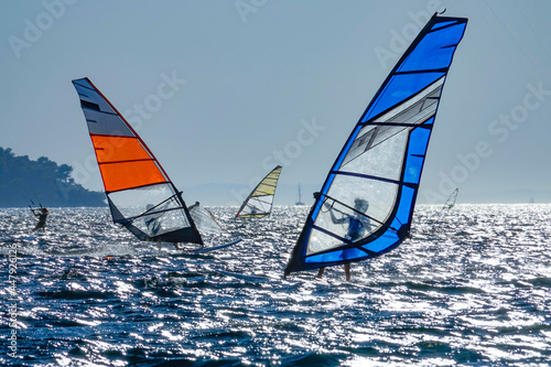 Canvas Print SILHOUETTE: Popular surfing spot in Adriatic is full of windboarders at sunset