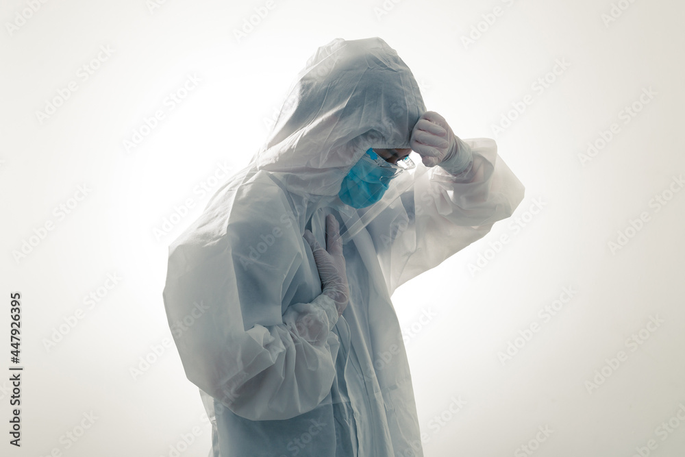 Crying volunteer during COVID-19 in serious pandemic crisis. Healthcare workers in hazmat suit PPE with emotional because of over work during Coronavirus crisis death, despair, mental health anxiety