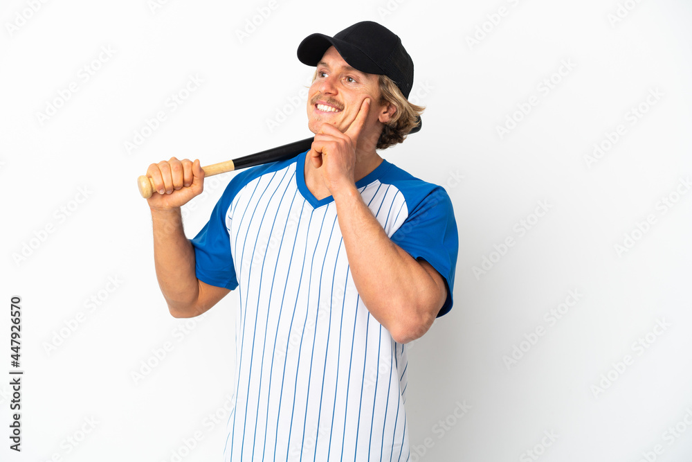 Young blonde man playing baseball isolated on white background thinking an idea while looking up Young blonde man playing baseball isolated on white background thinking an idea while looking up
