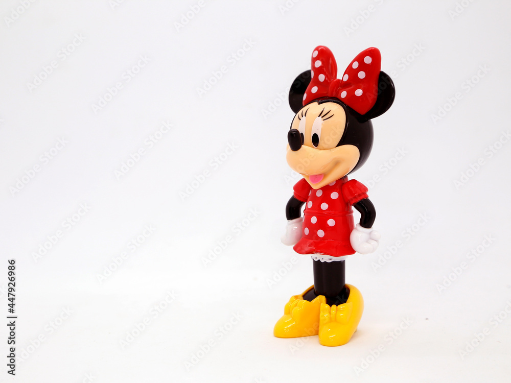 Minnie Mouse in her classic red polka dot dress. Toy. Cartoon character  from Walt Disney Pictures Studios. Minnie is Mickey Mouse's girlfriend.  Plastic doll. Daisy duck's friend. Isolated white. Stock Photo |