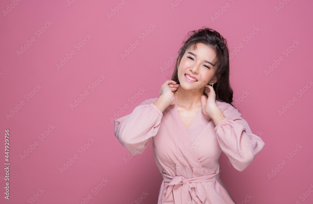 Portrait beautiful young woman in the studio on pink background
Portrait beautiful young woman in the studio on pink background