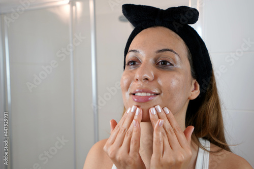 First step, removing make up with cleansing oil. Beautiful young woman using cleansing oil eco-friendly to remove makeup without cotton pad.