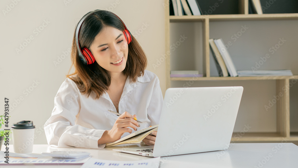 Young Asian businesswoman working on laptop and analyzing financial accounting graphs in home office
