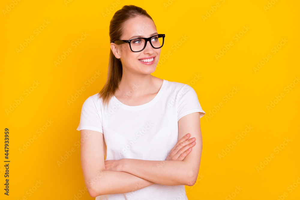 Photo of young cheerful young happy positive woman look empty space hands crossed isolated on yellow color background Photo of young cheerful young happy positive woman look empty space hands crossed isolated on yellow color background