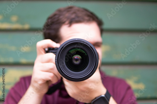 Obraz na płótnie Half length of young beautiful man outdoor in the city holding digital camera, shooting - photography, creative, artist concept
w salonie