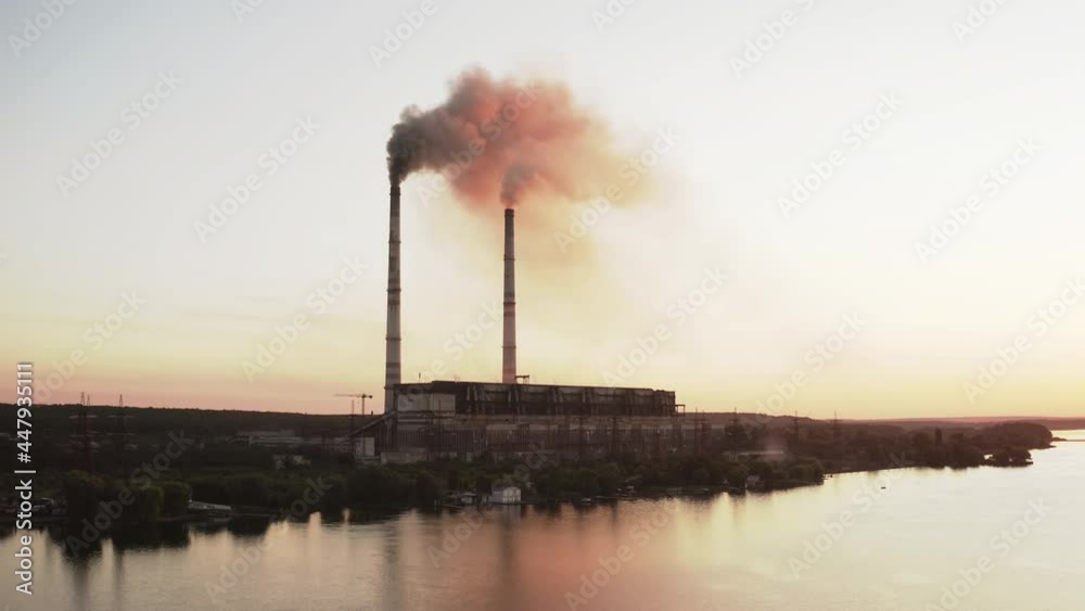 Industrial zone with large chimney. Aerial view of high smoke stack with smoke emission Industrial zone with large chimney. Aerial view of high smoke stack with smoke emission