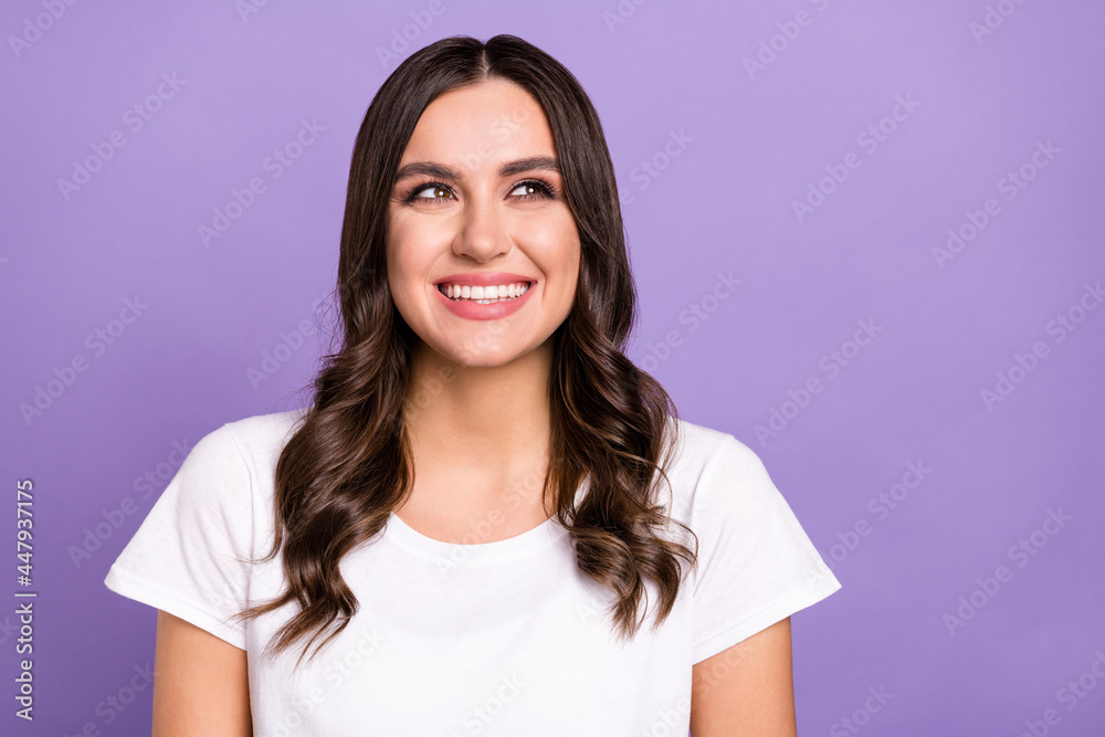 Photo of lovely brunette millennial lady look up wear white t-shirt isolated on violet color background Photo of lovely brunette millennial lady look up wear white t-shirt isolated on violet color background
