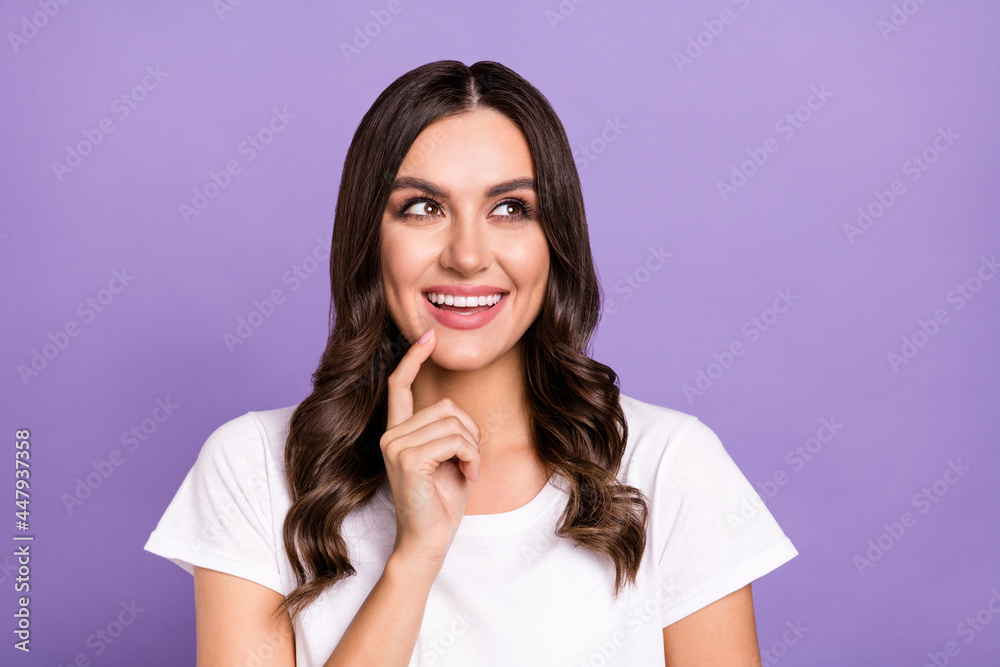 Photo of cute brunette young lady look empty space wear white t-shirt isolated on violet color background Photo of cute brunette young lady look empty space wear white t-shirt isolated on violet color background