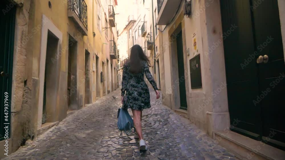 beautiful woman in black dress and glasses on the streets of portugal. tourist girl on a hot summer day. enjoying food and architecture beautiful woman in black dress and glasses on the streets of portugal. tourist girl on a hot summer day. enjoying food and architecture