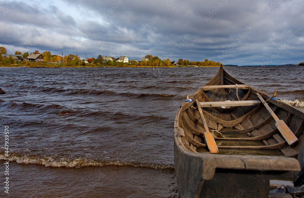 Russia. Republic of Karelia. Boat on the old wooden pier of Lake Vodlozero in the village of Kuganavolok.