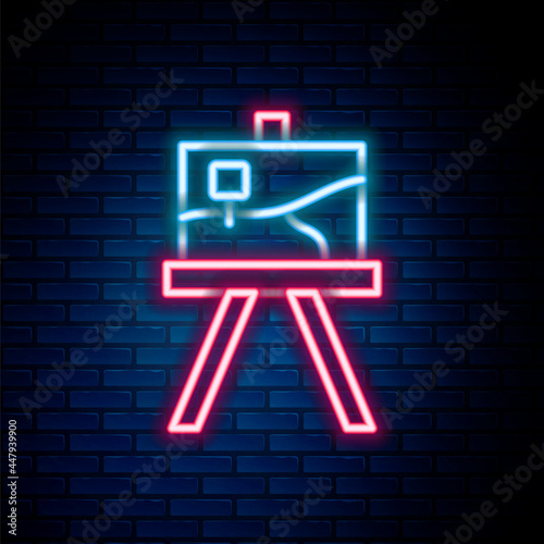 Glowing neon line Wood easel or painting art boards icon isolated on brick wall background. Colorful outline concept. Vector