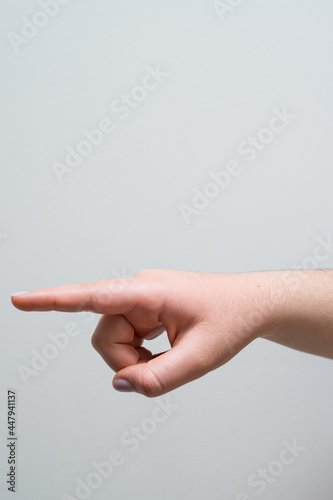 Caucasian hand pointing left on a white background 