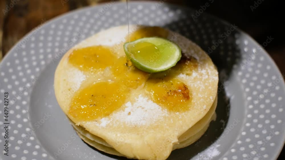 Maple Syrup Poured over Banana Pancakes and lime Video. High quality 4k footage Maple Syrup Poured over Banana Pancakes and lime Video. High quality 4k footage