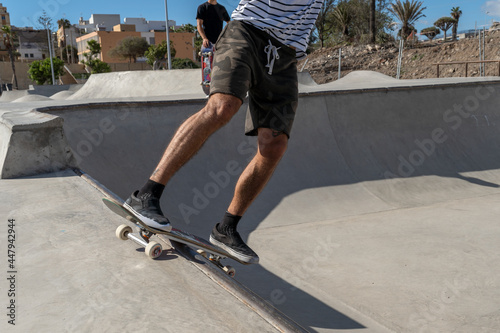 Young skateboarder man does a trick called `