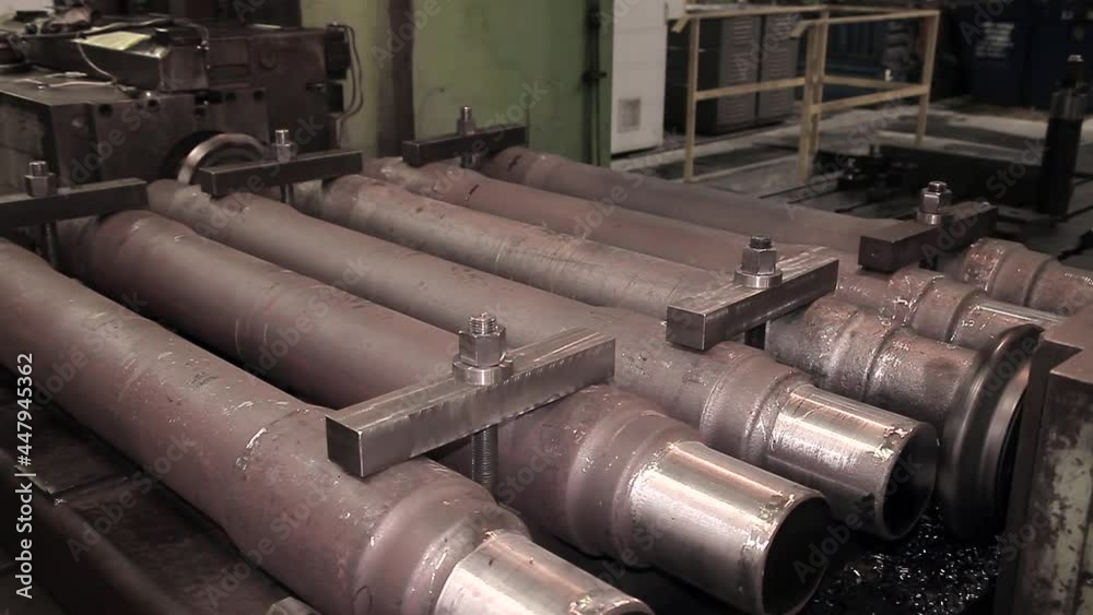 Close-up of a section of steel pipes stacked on top of each other. conveyor production of iron products