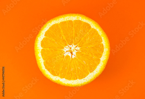 Close up photo of orange texture on the orange background. Fruit cut in half, inside, macro view. Minimalism, original and creative image. Beautiful natural wallpaper.