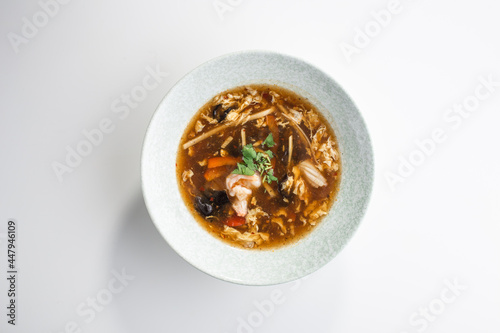 asian sour spicy seafood Soup with Shrimps and Fresh Vegetables isolated on white background
