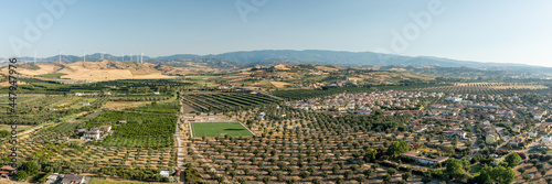Panoramic view of the Calabrian hinterland, olive fields and wind turbines in the background, Calabria, Italy.