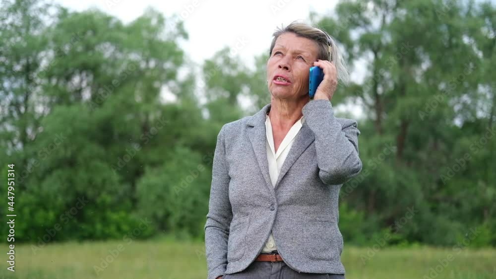 attractive senior business woman talking on phone, relax in park attractive senior business woman talking on phone, relax in park