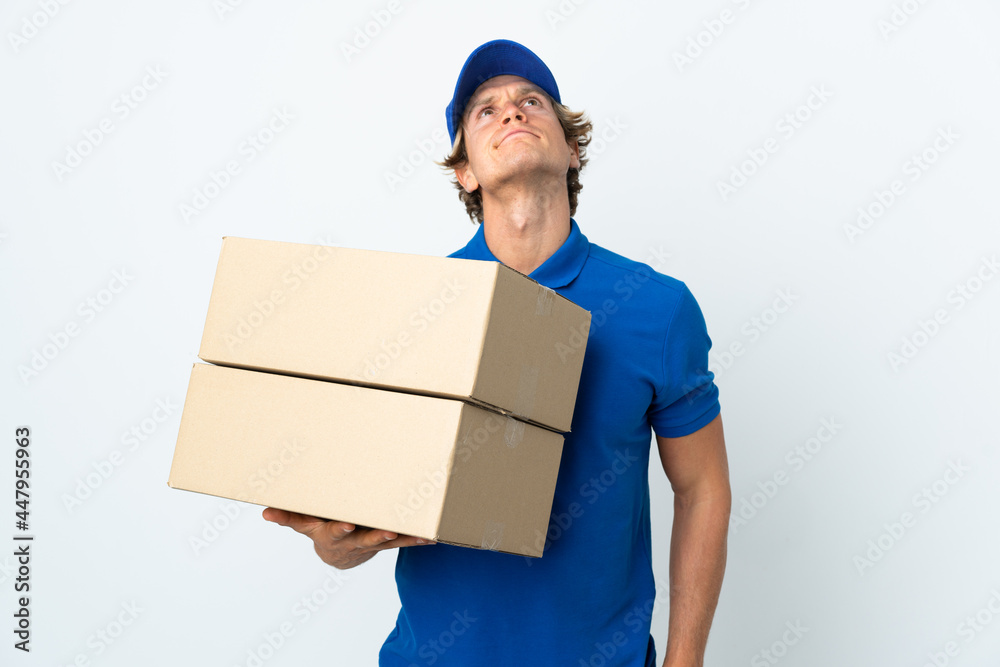 Delivery man over isolated white background and looking up Delivery man over isolated white background and looking up