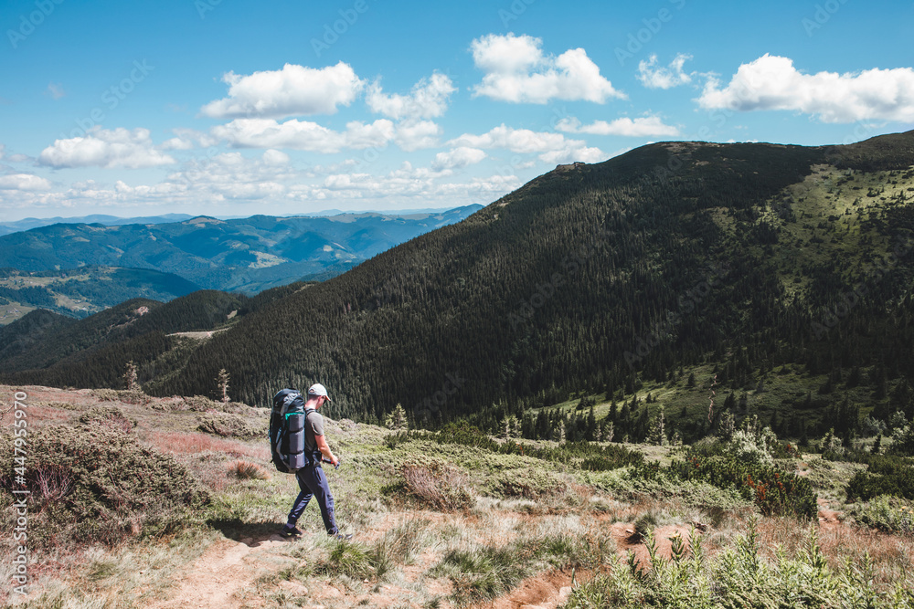young hiker man in mountains. summer trekking path young hiker man in mountains. summer trekking path