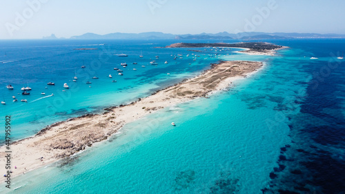 Aerial view of the beaches of Ses Illetes on the island of Formentera in the Balearic Islands, Spain - Turquoise waters on both sides of a sand strip in the Mediterranean Sea