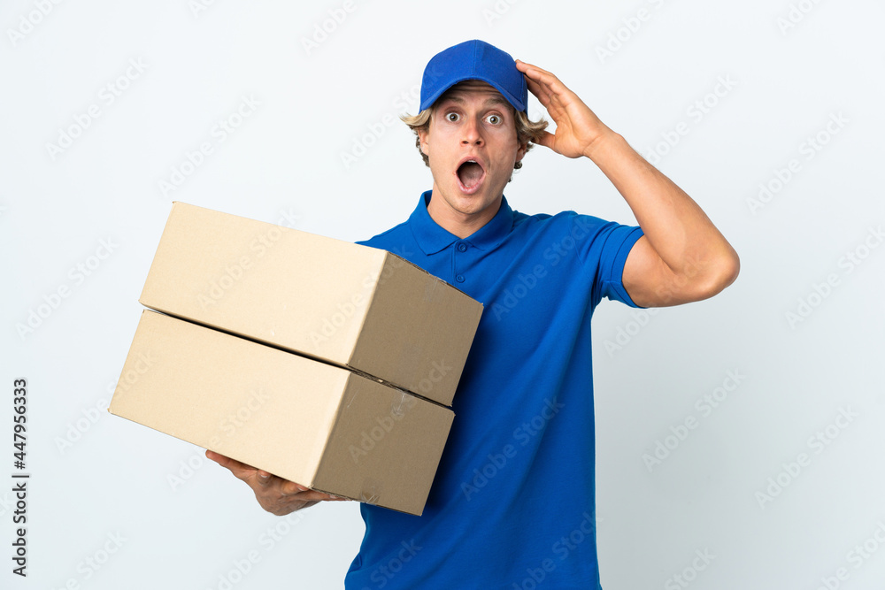 Delivery man over isolated white background with surprise expression Delivery man over isolated white background with surprise expression