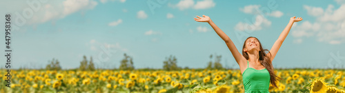 Fotografija Spring happy woman with open arms walking in sunflower field enjoying free nature landscape banner panoramic