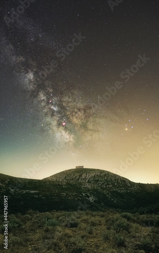 Milky Way over Montgrí Castle in Costa Brava during a vacation and warm summer night. 