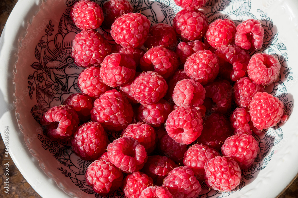 Raspberries in a plate. The collected berries of a raspberry Raspberries in a plate. The collected berries of a raspberry