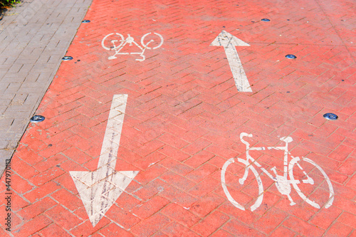 Red bicycle lane with two-way arrows photo