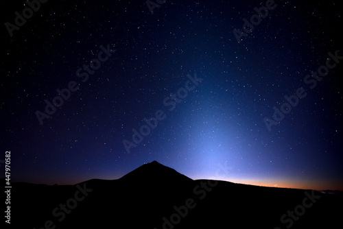 Landscape of zodiacal light and the Milky Way on blue night