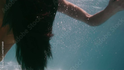 Young woman falls inert in swimming pool