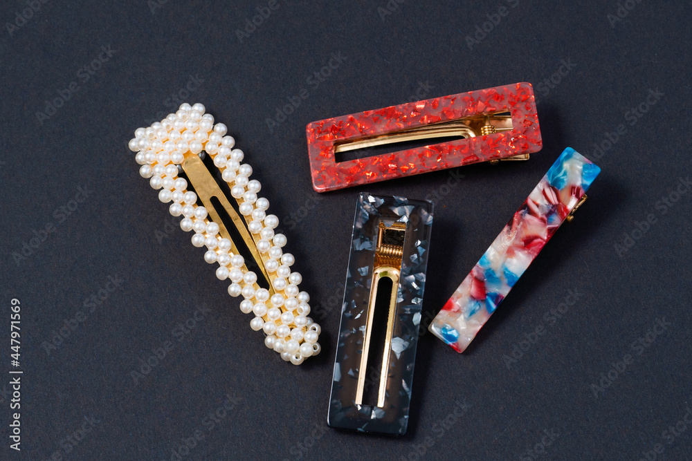 hair clips of different colours and different styles on a dark background hair clips of different colours and different styles on a dark background