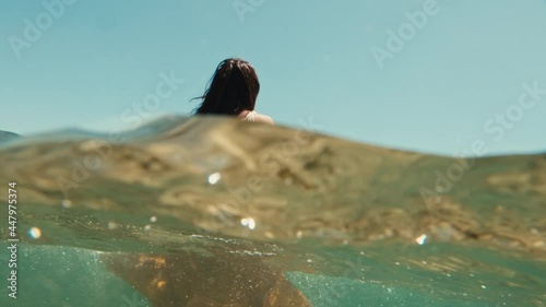 Woman wanders into the blue sea