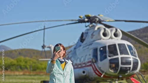Passenger aircraft journey woman makes selfie at helicopter