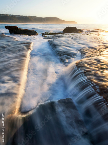 water flowing on the rocks at the beach